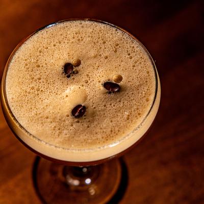 Espresso Martini garnished with coffee beans.