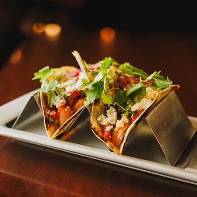 Shrimp Tacos, with sweet corn and tomato salsa, radish, cheese, and cilantro.