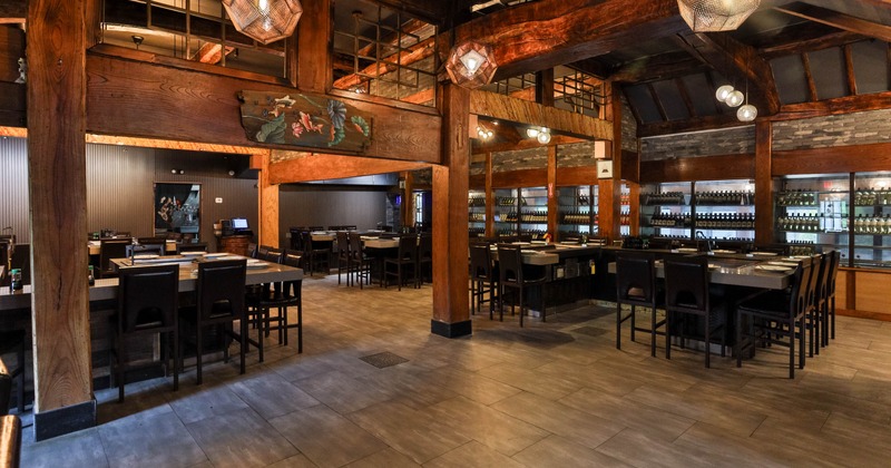 Interior, wooden beams, tiled floor, pendant lights, and tables with chairs