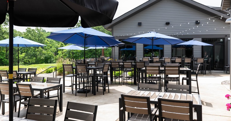 Exterior, partially covered seating area, high and regular tables with chairs