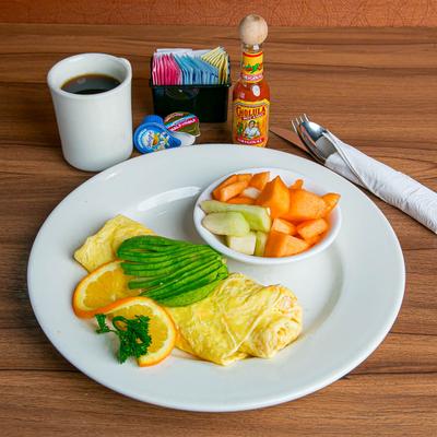 California omelet and a side of fresh fruit, coffee and condiments.
