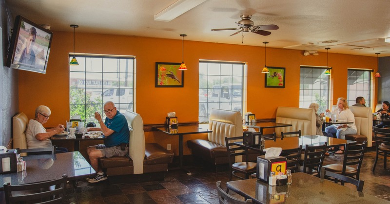 Interior, restaurant booths with guests dining