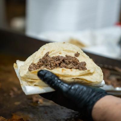 Chef preparing a taco.