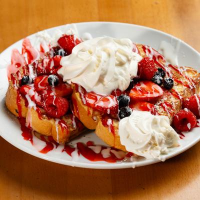 TOPPED WITH FRESH BERRIES AND WHIP CREAM AND POWDER SUGAR.