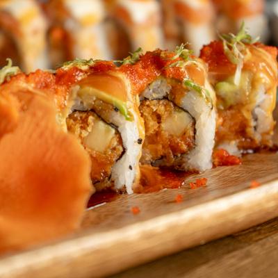 Tennessee Beauty Roll topped with salmon, avocado, masago, and green onion.