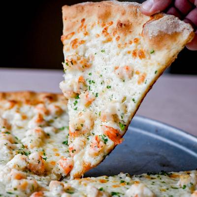 A slice of Shrimp Scampi Pizza.