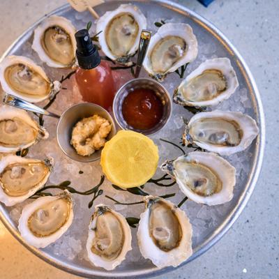 Oysters on The Half Shell served over ice with condiments.