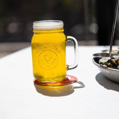 A mason jar with beer accompanying the seafood tower.