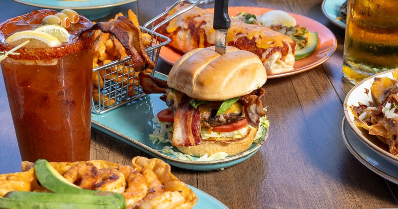 Variety of restaurant meals served on the table alongside drinks