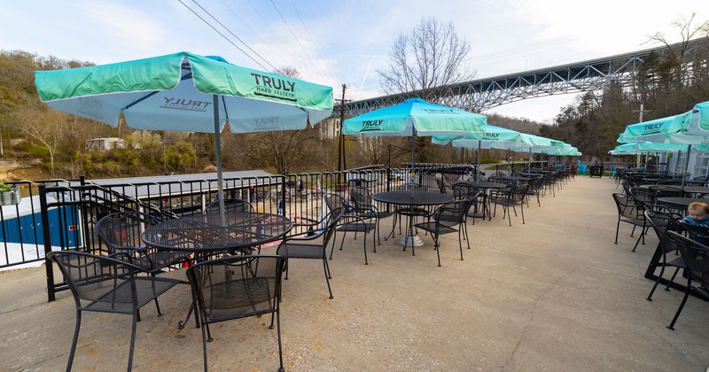 Patio with guests tables and sunshade umbrellas