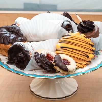 A decorative plate holds an assortment of sweet pastries.