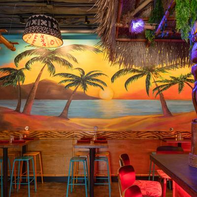 Wall mural depicting a beach and palm trees.