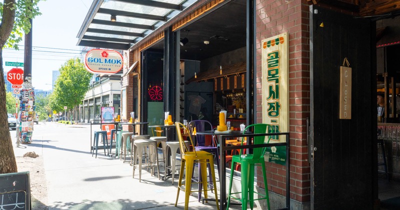 Exterior, bar stools and tall tables in front of the restaurant
