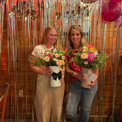 Two people holding flowers.