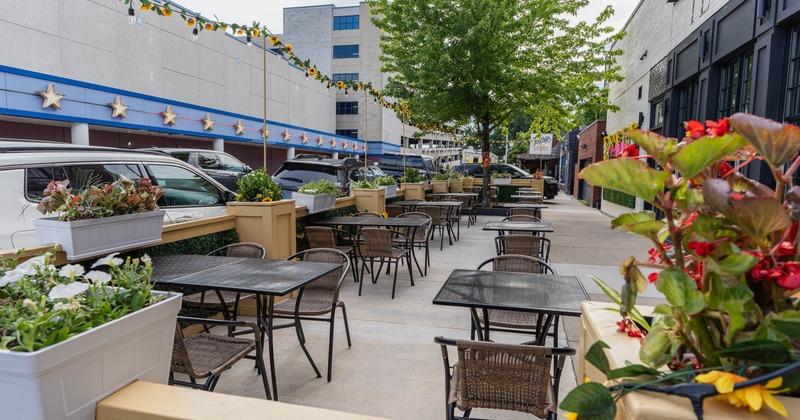 Exterior, patio, tables for two and four, concrete flooring, flower pots as a decoration