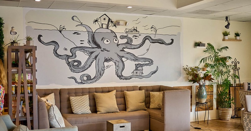 Lounging area, wall mural depicting a giant octopus