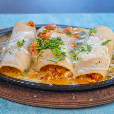 Sizzling enchiladas with melted cheese.