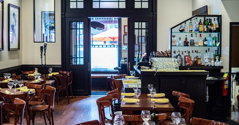 Interior, tables with wine glasses and tableware, a bar