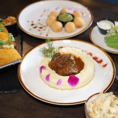 Short ribs in sauce, on a bed of mashed potatoes.