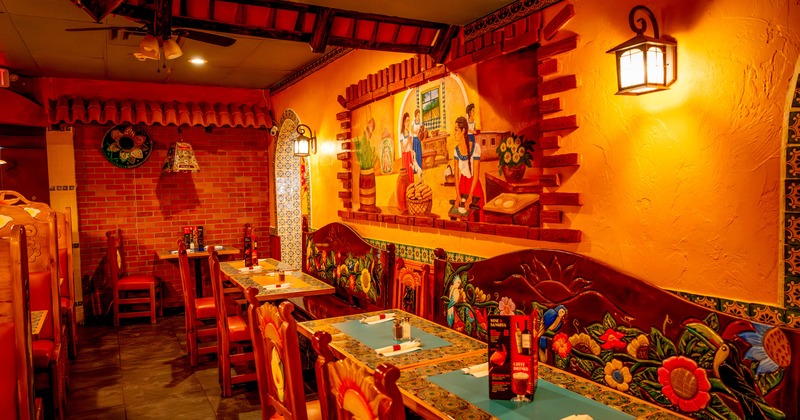 Interior, dining area, long decorated wooden benches with tables and chairs, wall mural