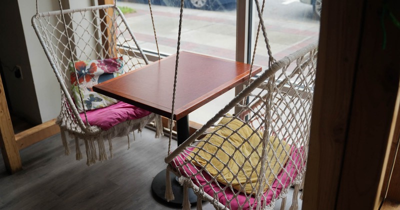 Interior, seating area with hanging chairs and table