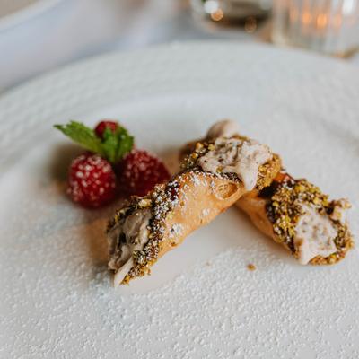 Cannoli plate garnished with raspberries