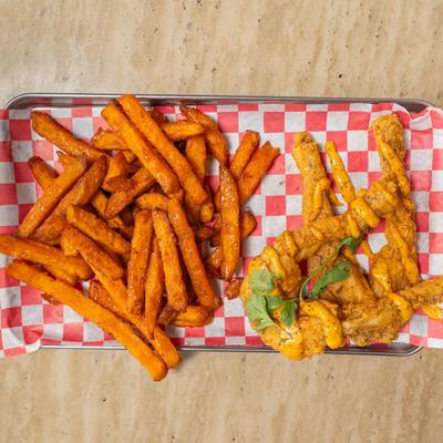 Cajun Fried Frog Legs Basket with a side of sweet potato fries.