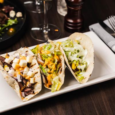 Trio of Tacos with shrimp, steak, tina and various toppings.