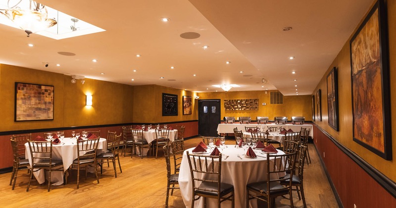 Interior, rounded tables ready for guests