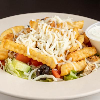 Grilled chicken salad with lettuce, tomatoes, olives, grated cheese, and fries.