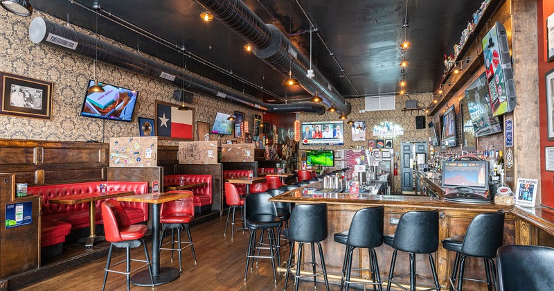 Interior, tables, booth seating and the bar with stools