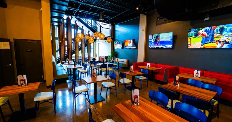 Interior, dining area wooden top tables for two and four, seating booths with tables