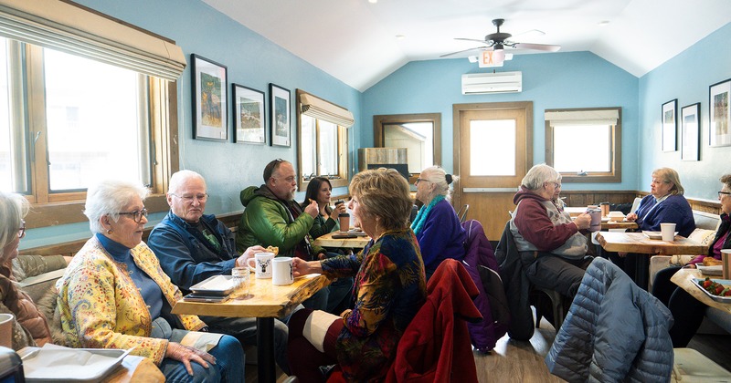 Interior space, seating area full of guests chatting and enjoying their food and drinks