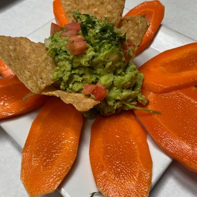 Decorated dish with green dip in the middle