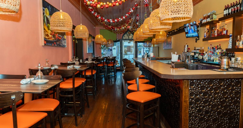 Interior, tables and chairs on the left, bar and bar stools on the right