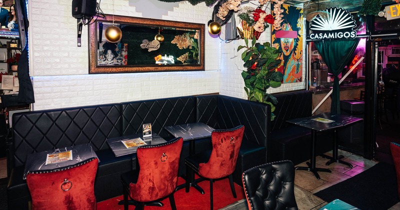 Interior, lounge area, corner banquette bench with tables and chairs, various deocratrion