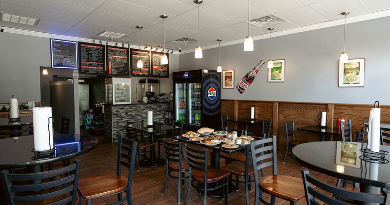 Interior, dining area, high and regular seating tables, checkout counter, drinks fridge