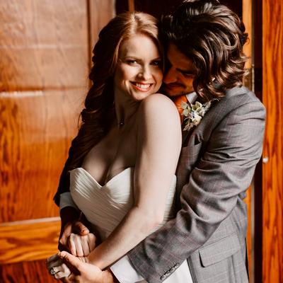 A newlywed couple hugging  on their wedding day.