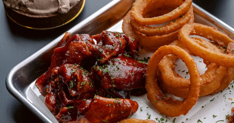 Glazed chicken wings and crispy onion rings