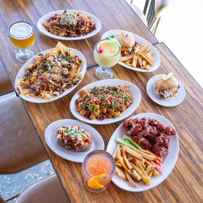 A table set with assorted dishes and cocktail drinks.