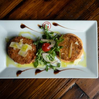 Crab Cakes served with lobster sauce and small salad.