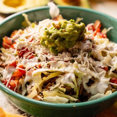 Chicken Burrito Bowl, with beans, lettuce, jack cheese, pico, sour cream, salsa, rice, and guac.