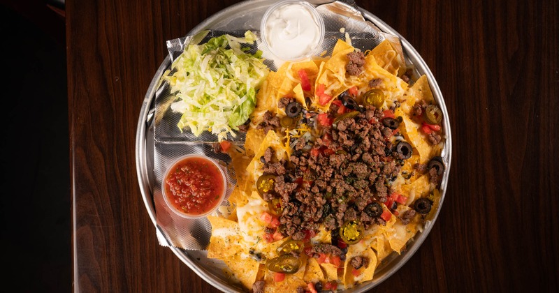 Original nachos served with shredded lettuce, sour cream and salsa