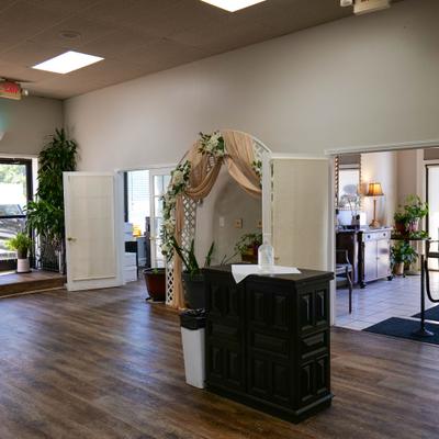 Venue's iterior with a dark counter and weding arc.