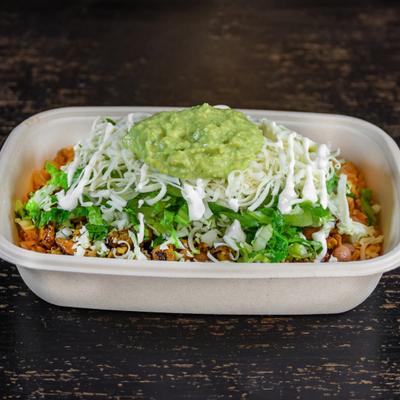 Burrito Bowl, with chicken, lettuce, cheese, onions, cabbage, sour cream, and avocado sauce.