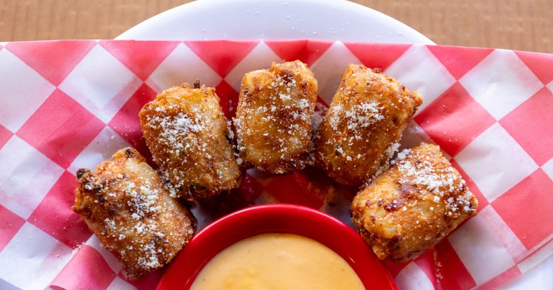 Tater kegs sprinkled with grated cheese served with beer cheese dip