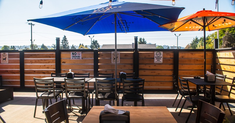 Outdoor seating area, tables, chairs, and parasols