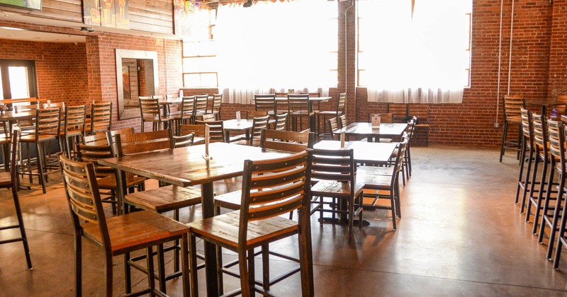 Dining area with tables and chairs, brick walls