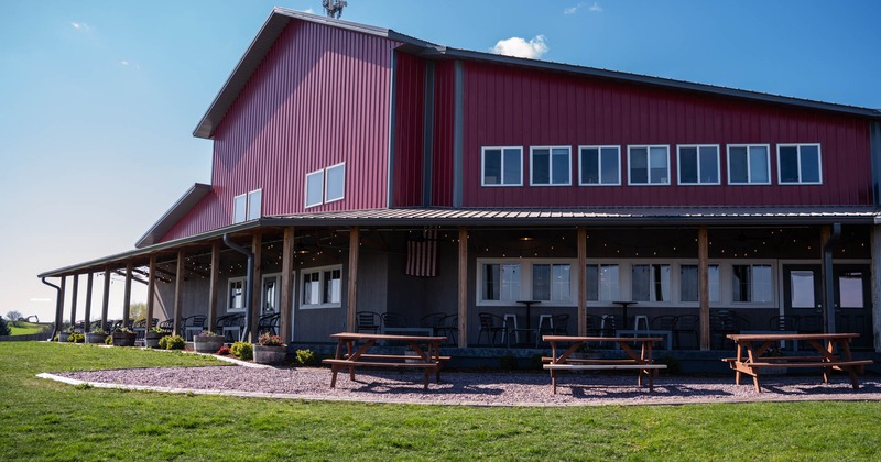 Exterior, restaurant's front view, wooden benches and tables in front of the porch