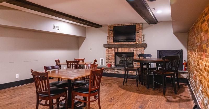 Interior, diner area, tables and chairs, fireplace behind